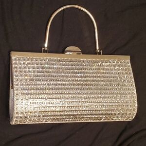 Silver clutch purse, beautiful rhinestones, metal handle, used one time.